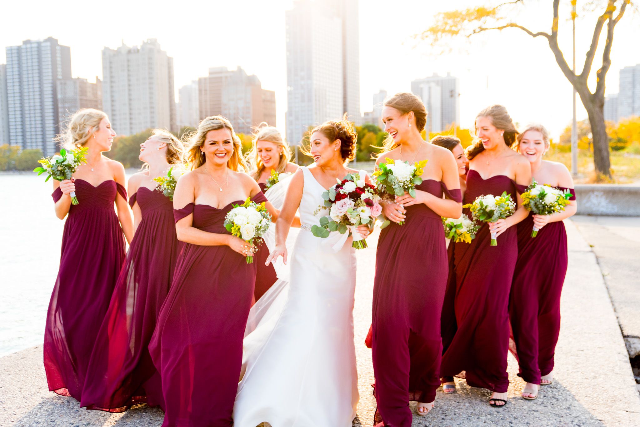 bridesmaids walk in the city during golden hour on chicago wedding day