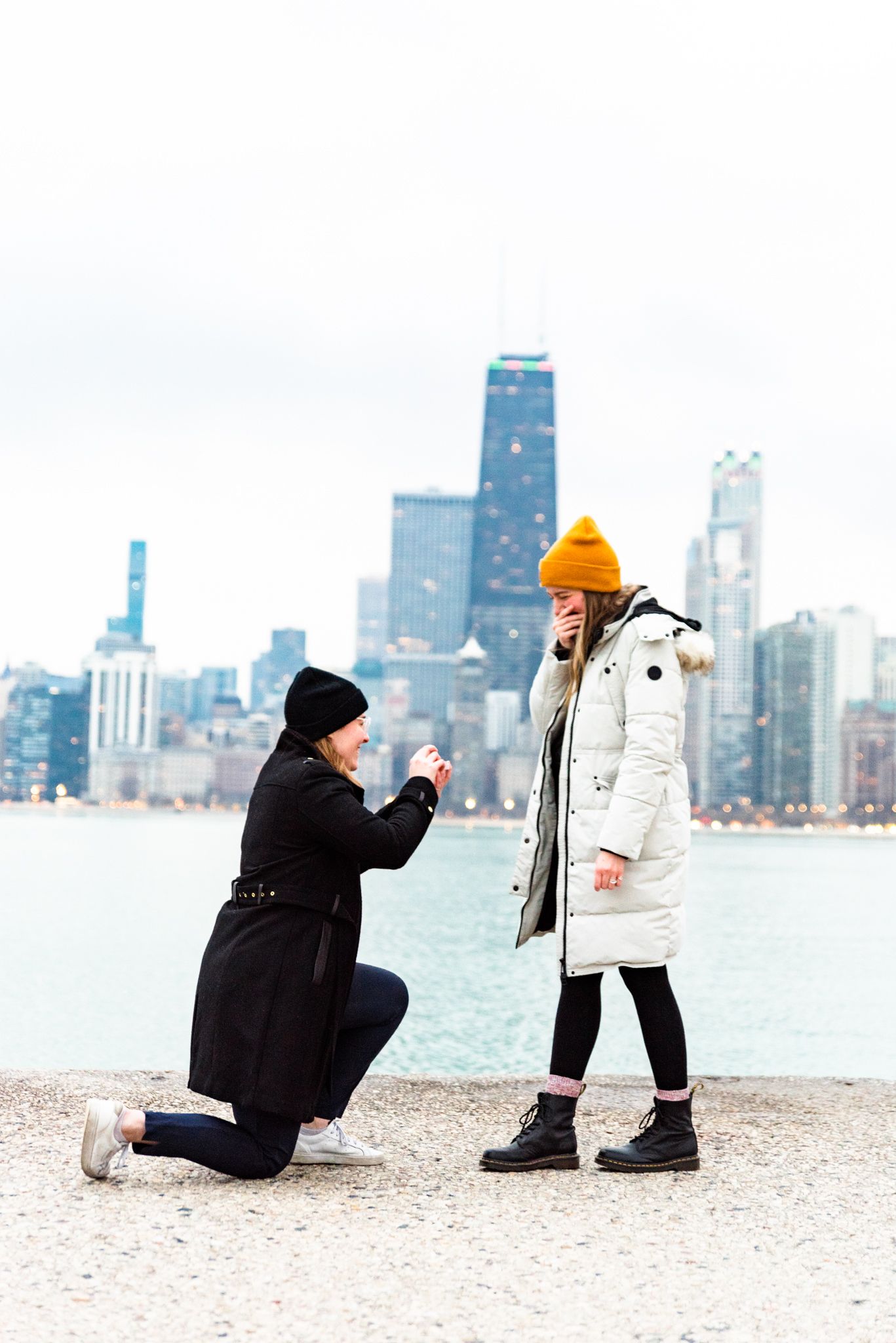 one woman on one knee proposing to girlfriend for Chicago proposal at North Avenue Beach