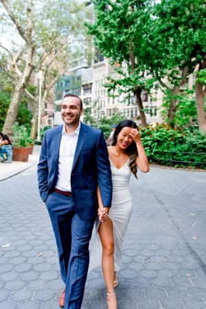 engaged couple holding hands walking through Flatiron District NYC