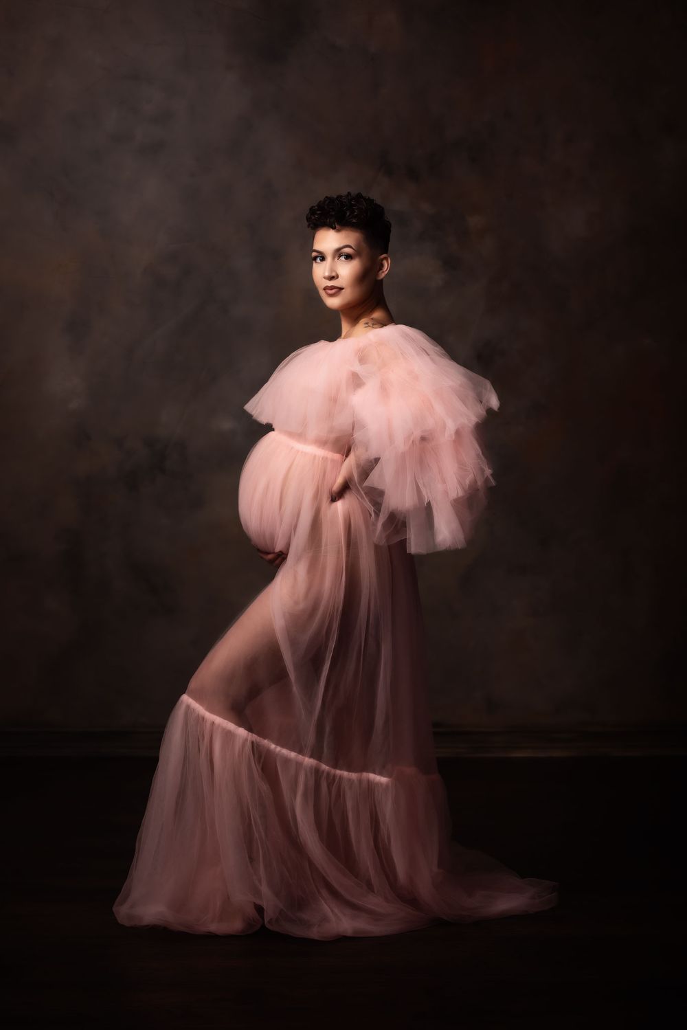 Omaha maternity portrait of a mama wearing a pink gown from Mama Bump rentals