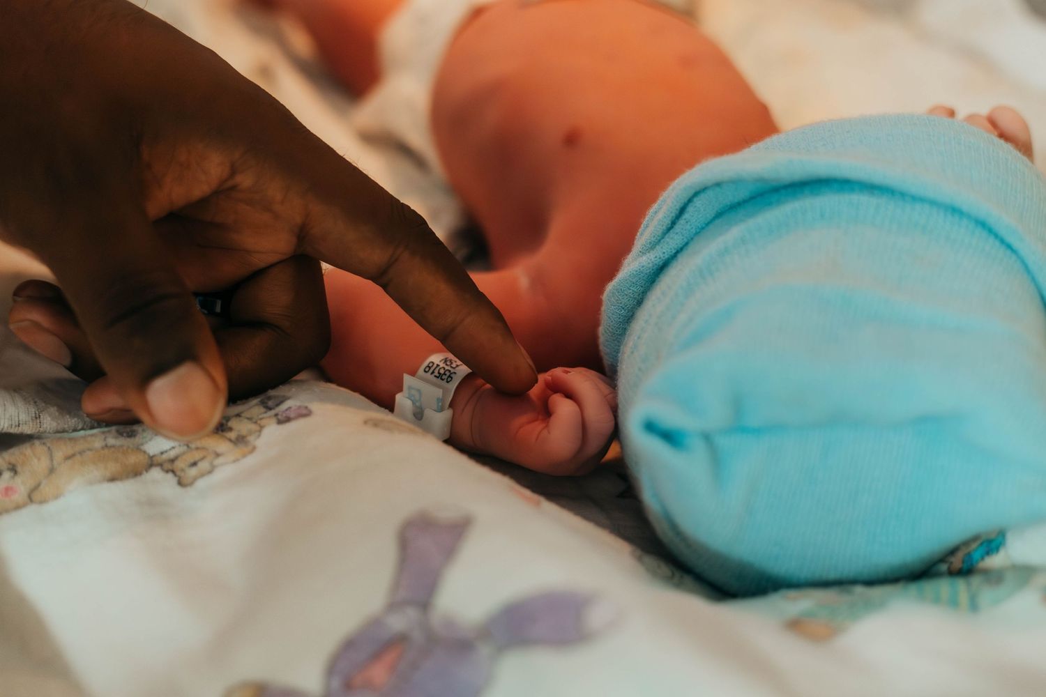 San Antonio Dad touching his baby for the first time after birth while mom rests