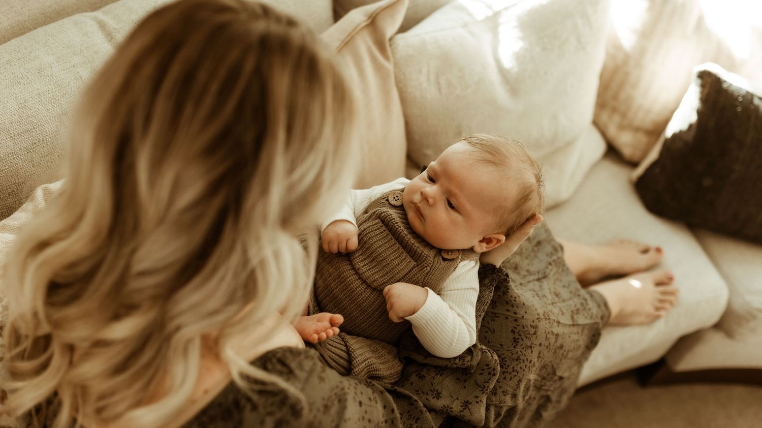 Mother gazing at her newborn son during their newborn photography session in Longmont, CO