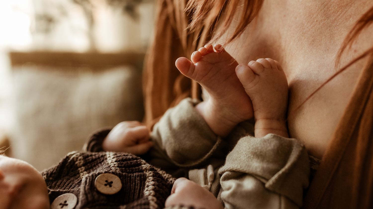 Baby toes resting against Mama's chest during their newborn photography session in Longmont, CO