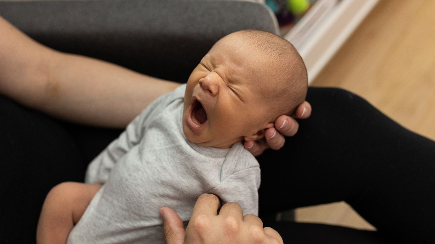 Newborn baby yawning during his Denver, Colorado newborn photography session