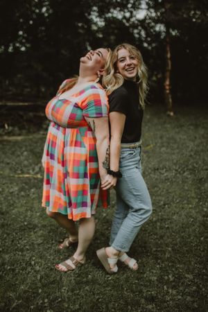 two best friends posing back to back