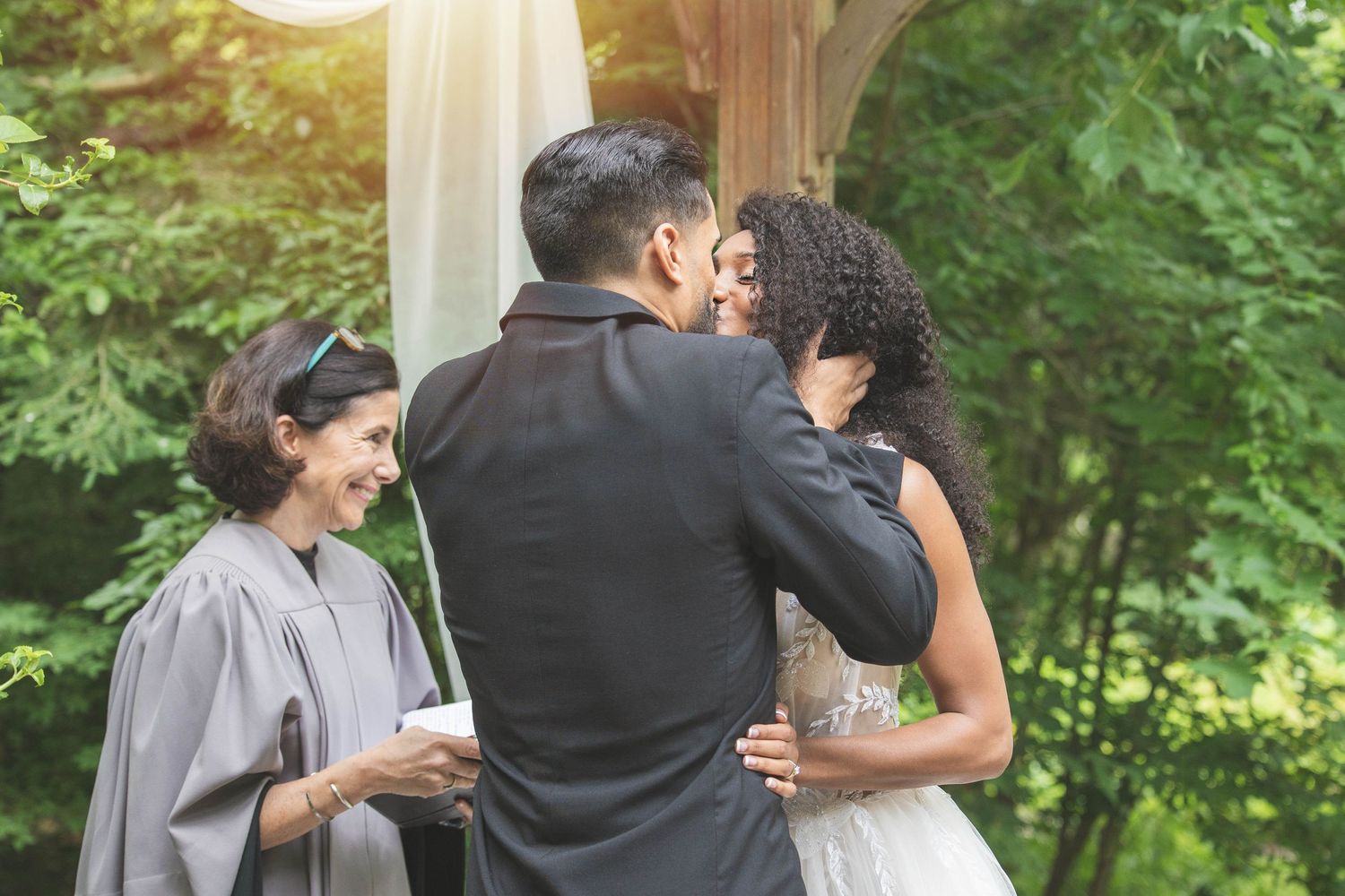 An emotional wedding ceremony moment captured during an outdoor garden celebration.