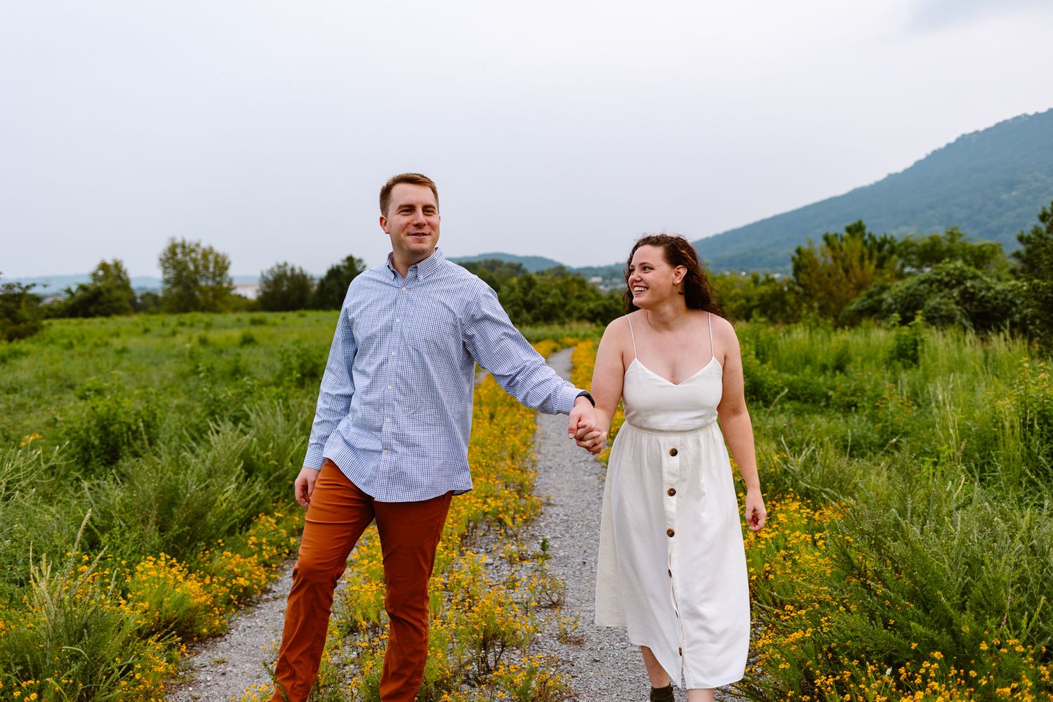 Riverwalk engagement in downtown Chattanooga in a field.