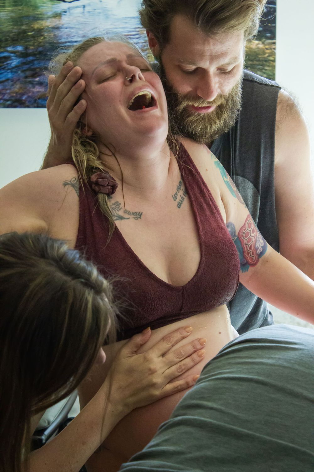 People sharing an intimate emotional moment together in a room with artwork.