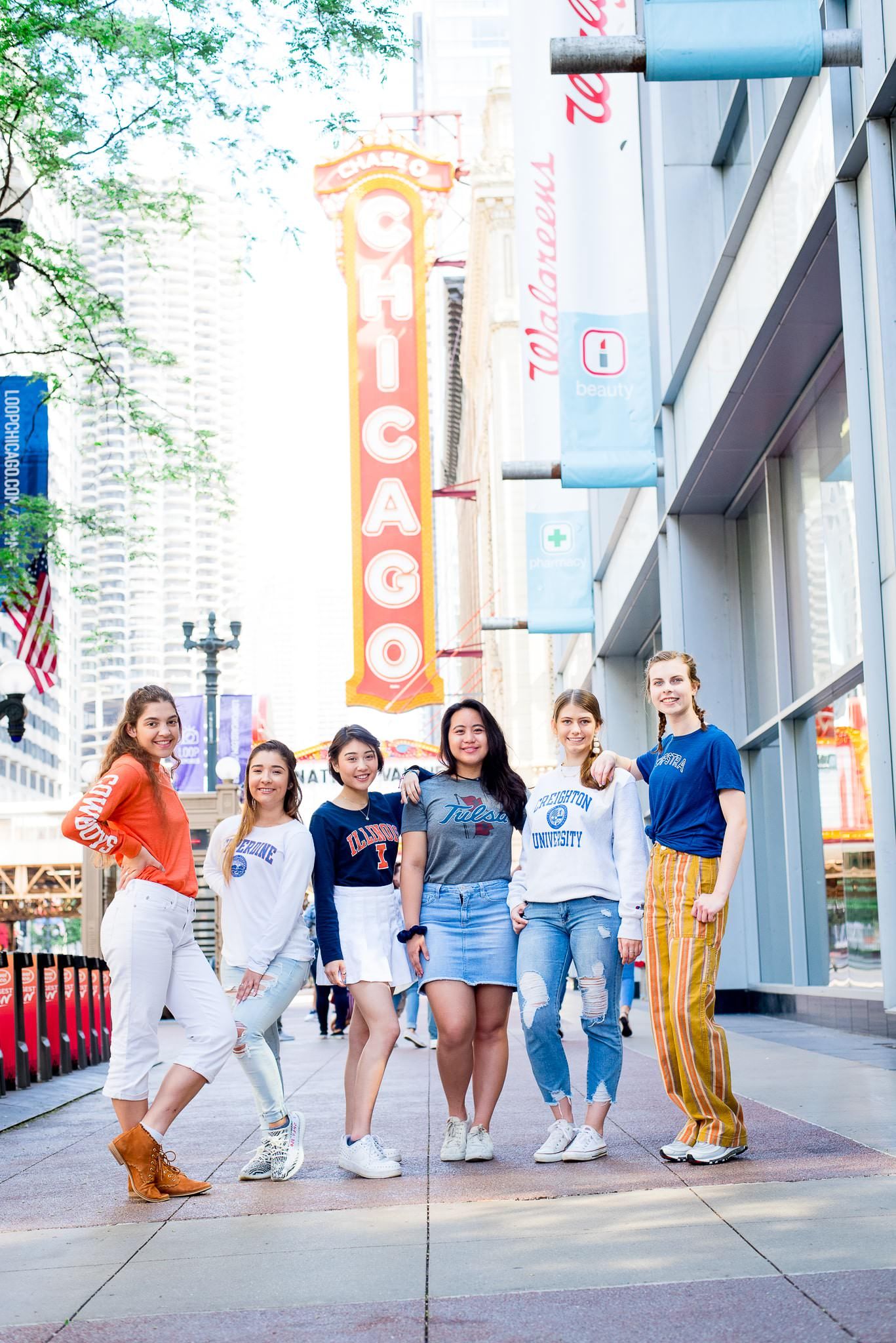 six senior girls in front of the Chicago Theater sign for Chicago senior pictures