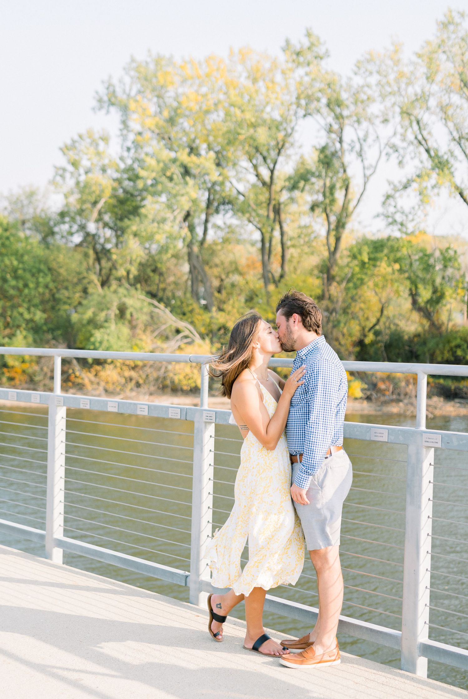 Des Moines Engagement photos at Grays Lake in downtown Des Moines, Iowa with light and airy photographer Nicole Laing