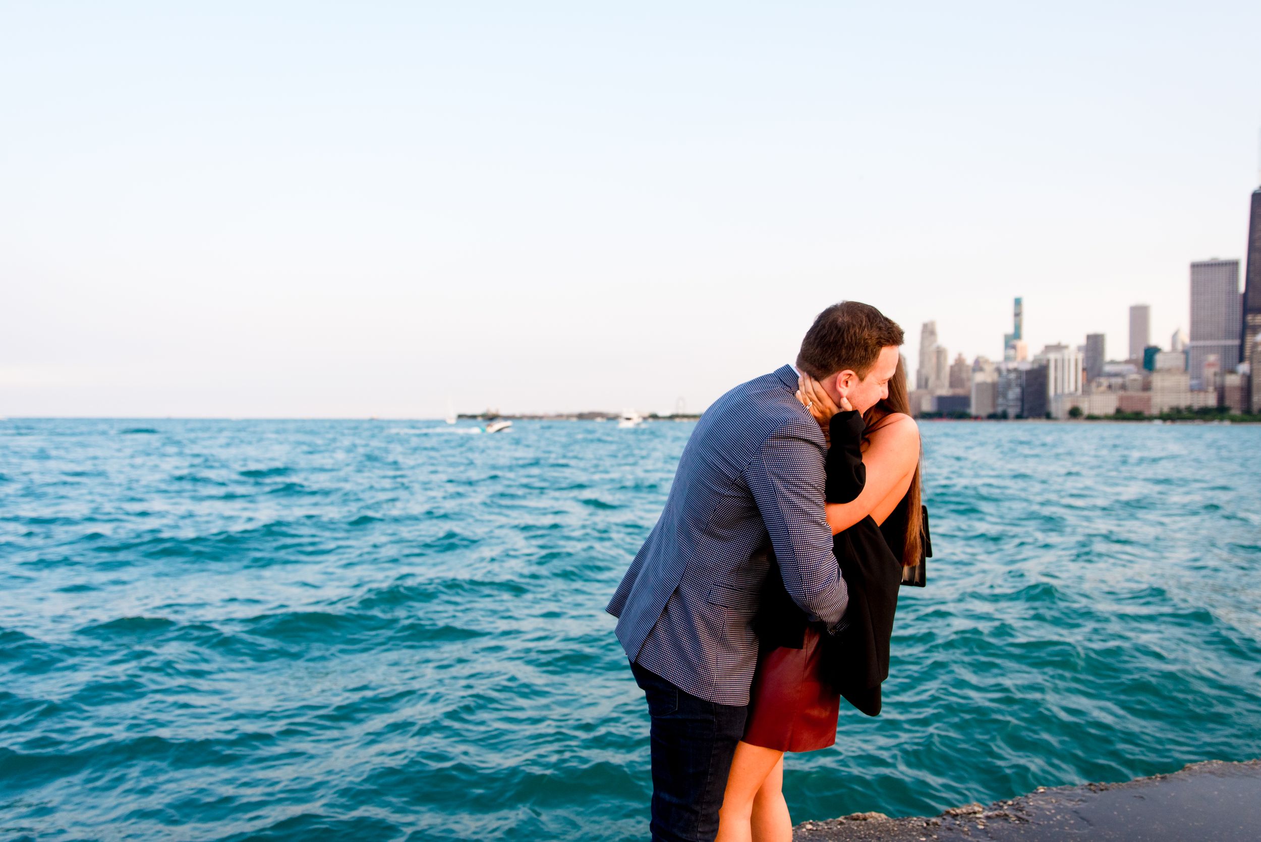 man and woman hugging after Chicago proposal at North Avenue Beach pier