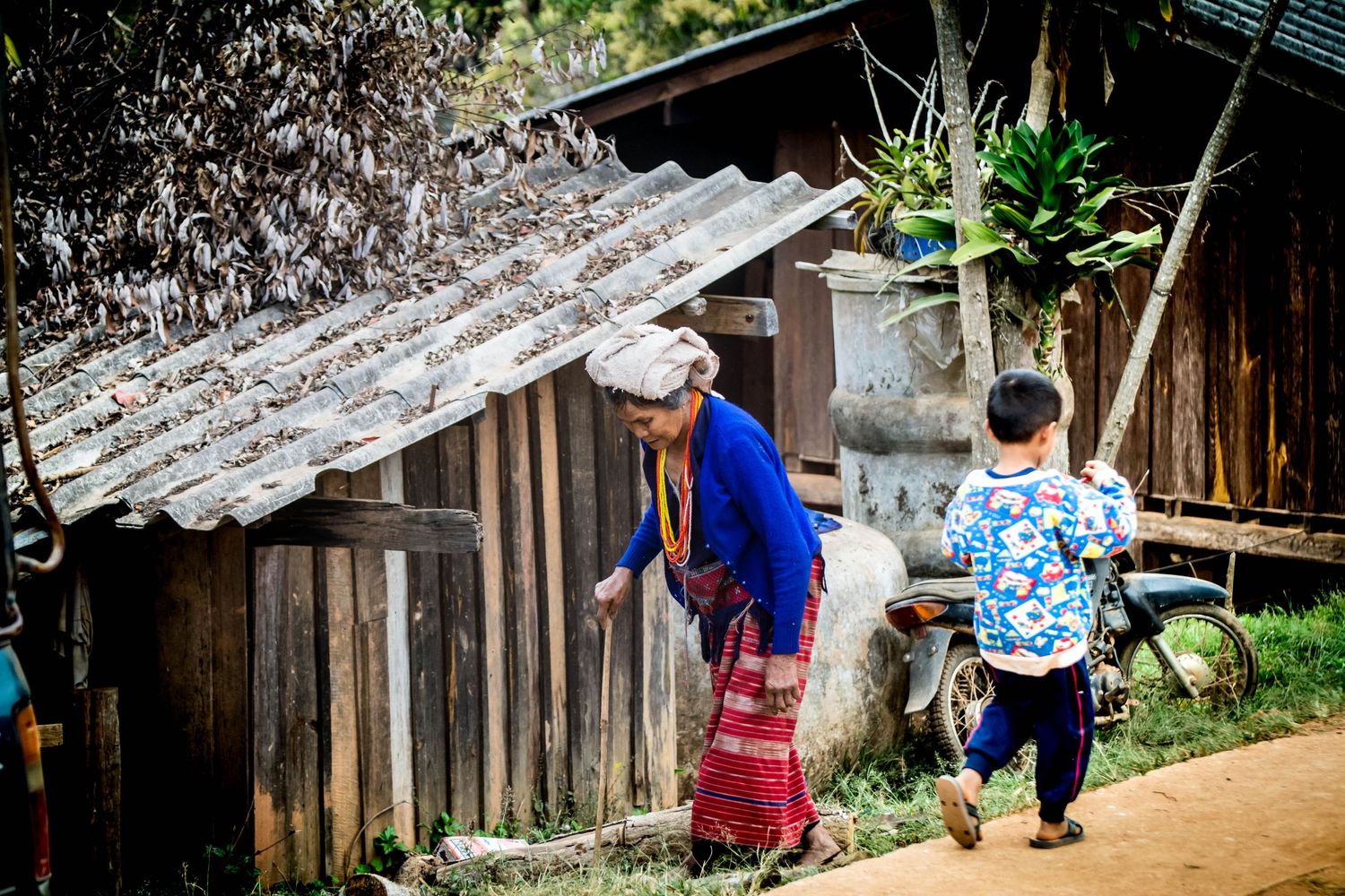 Environmental portrait of young and old life in a Akha Tribe village in Northern Thailand