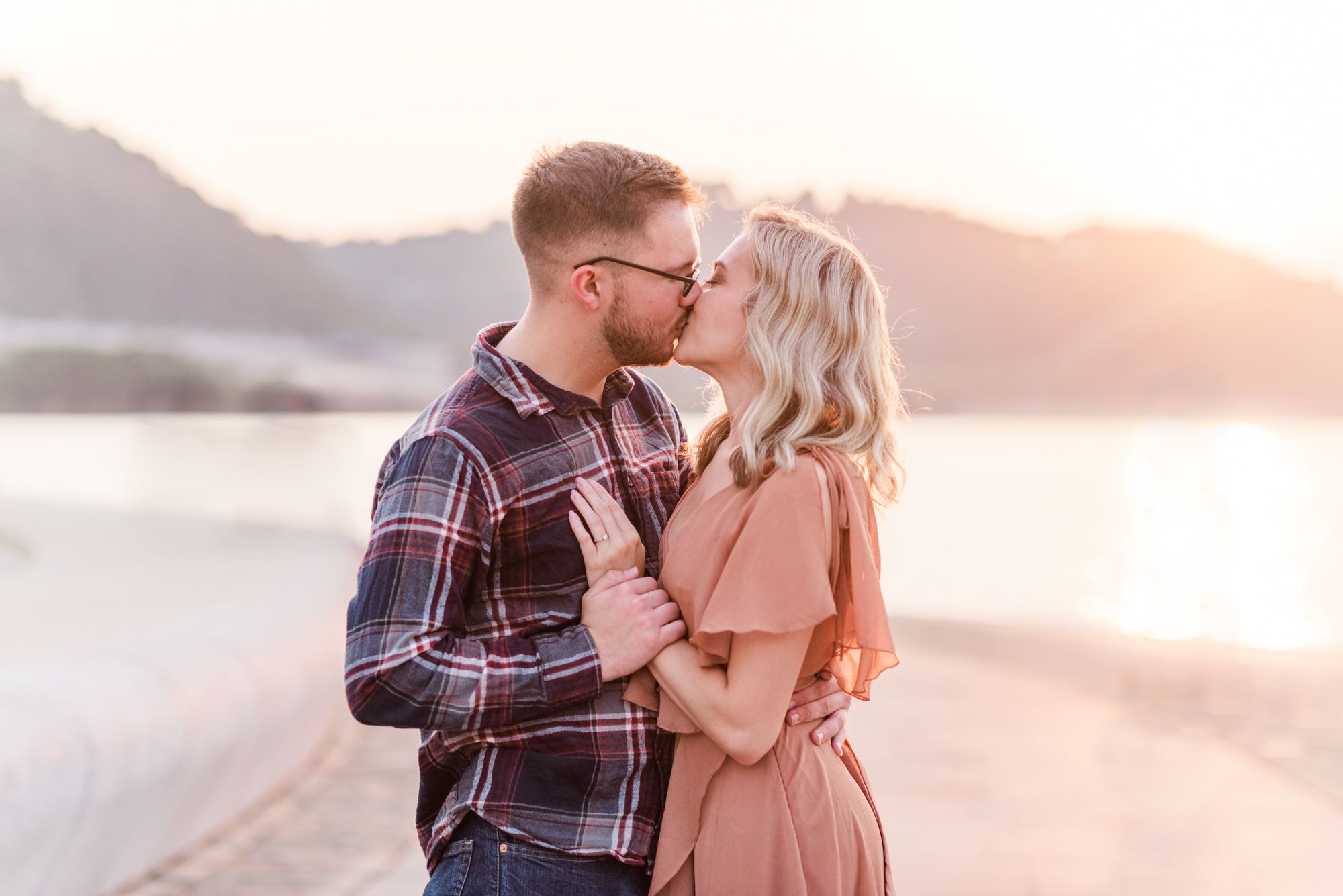 Newly engaged couple kissing at sunset at Point State Park in Pittsburgh, Pennsylvania