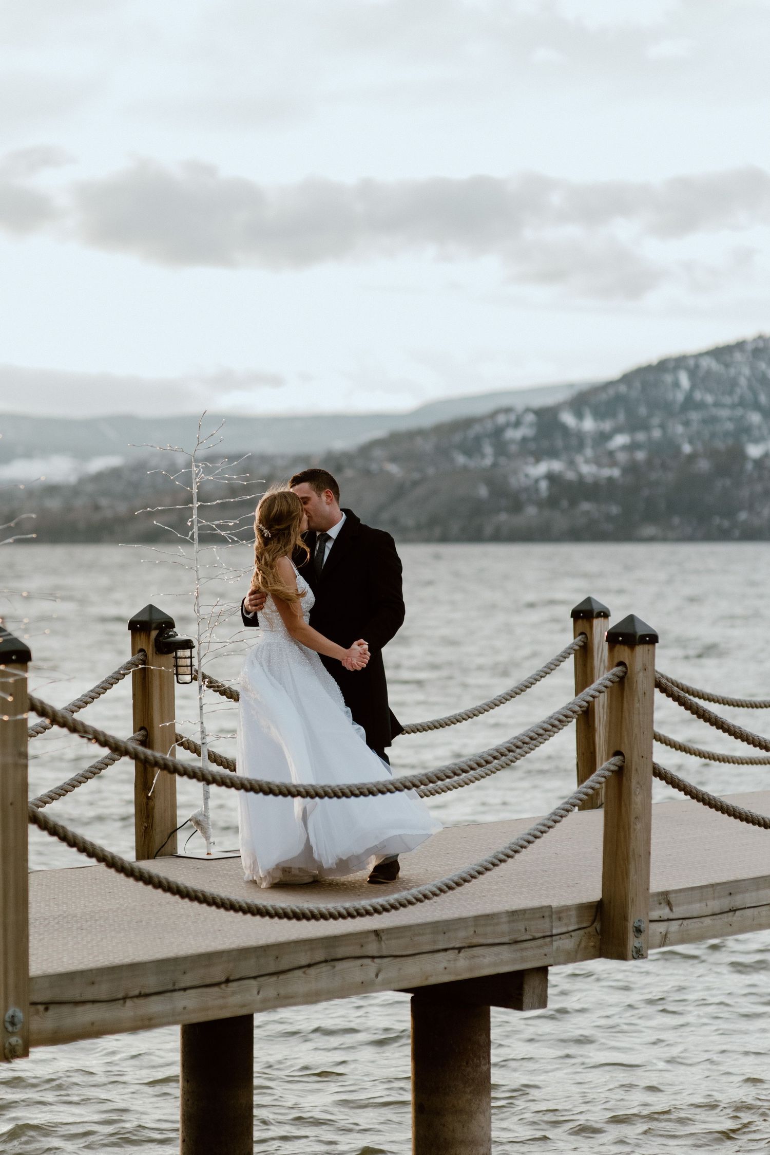 bride-and-groom-hugging-on-dock-at-Hotel-El-Dorado