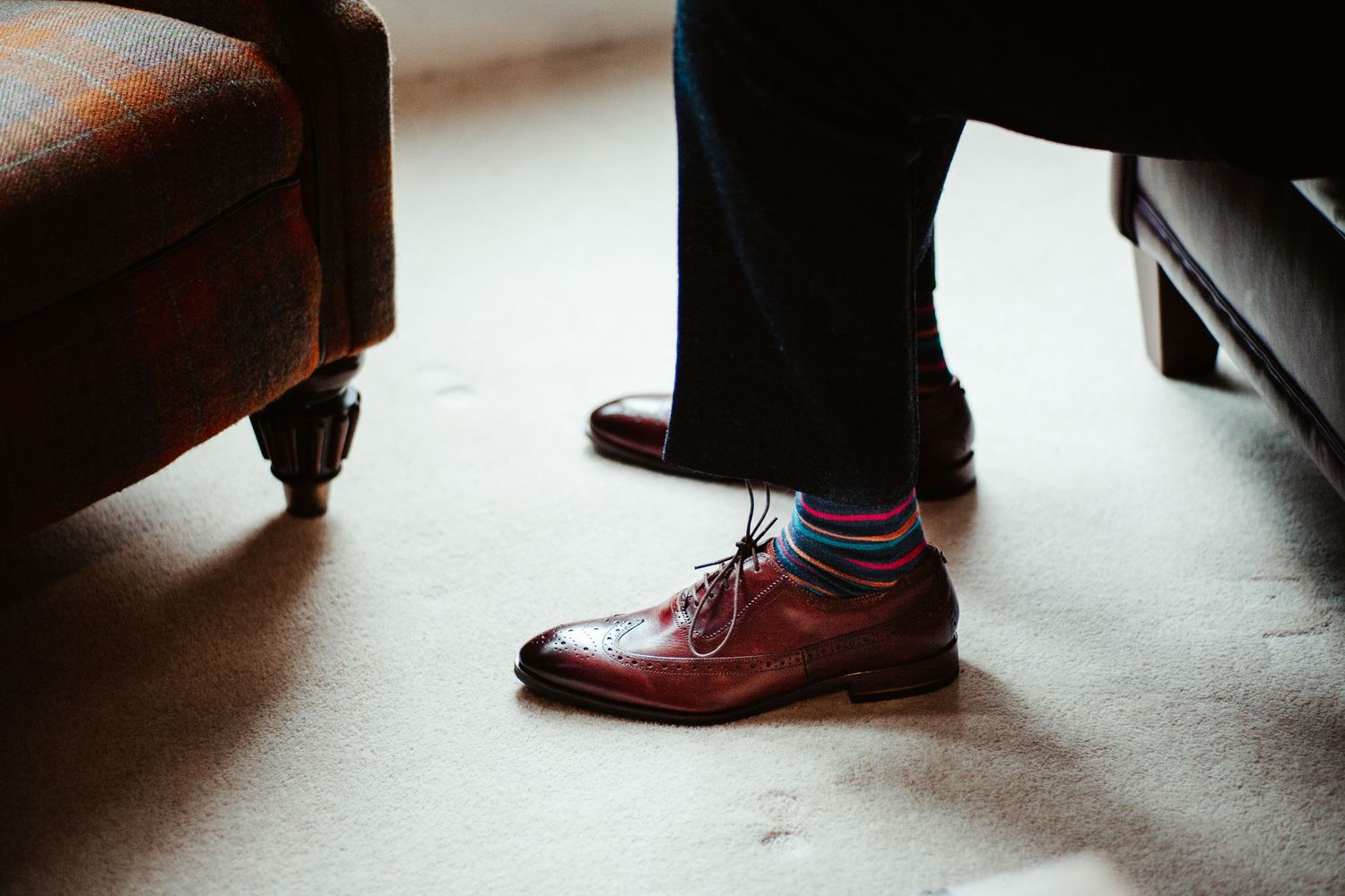 Groom wearing brown leather shoes and stripey socks