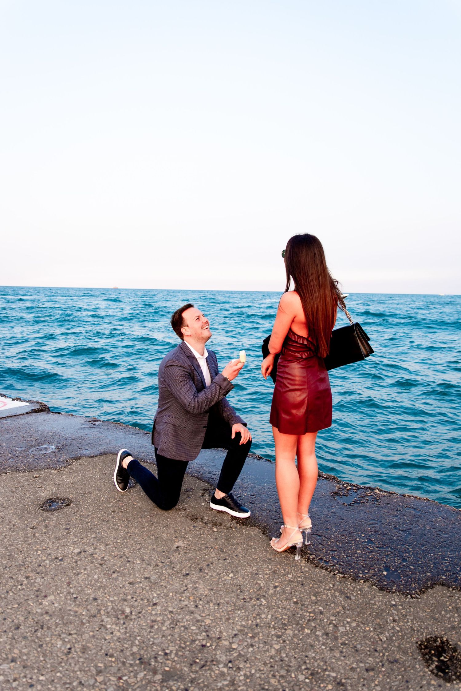 man in gray suit down on one knee for North Avenue Beach Chicago proposal