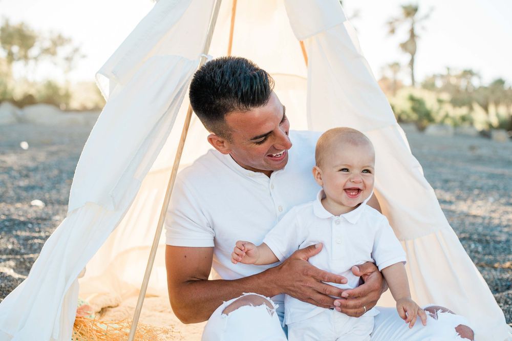 Dad and baby boy laughing together