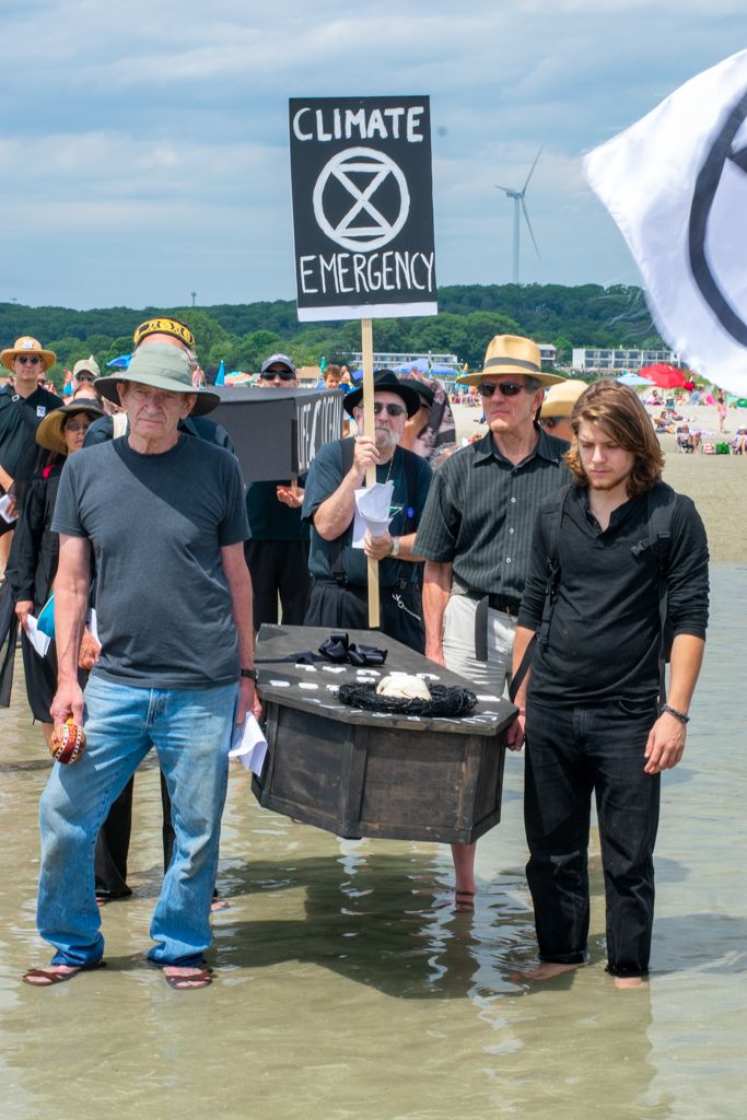 Funeral procession on Good Harbor Beach, Gloucester, Massachusetts warns of climate emergency