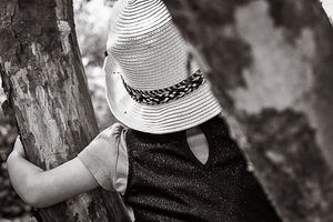 Black and white photo of girl in a hat at National Rhododendron Garden by Kate Cashin.