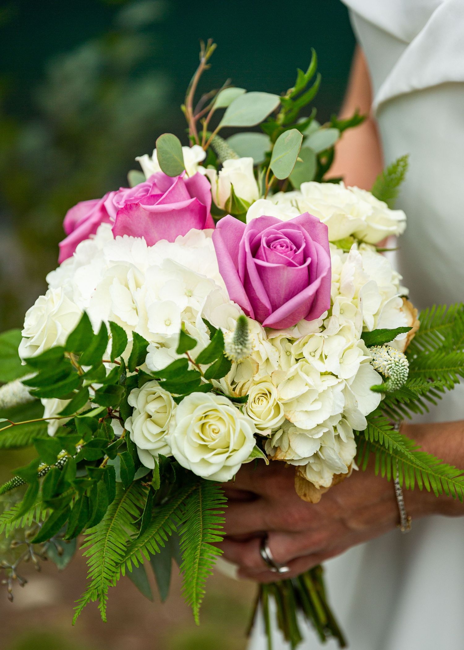 Closeup of a bridal bouquet with white flowers and pink roses
