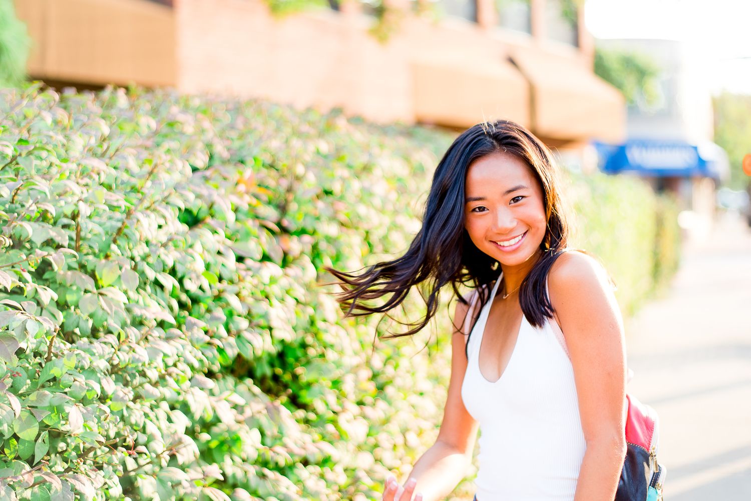 high school senior girl flipping her hair for her senior pictures in Chicago