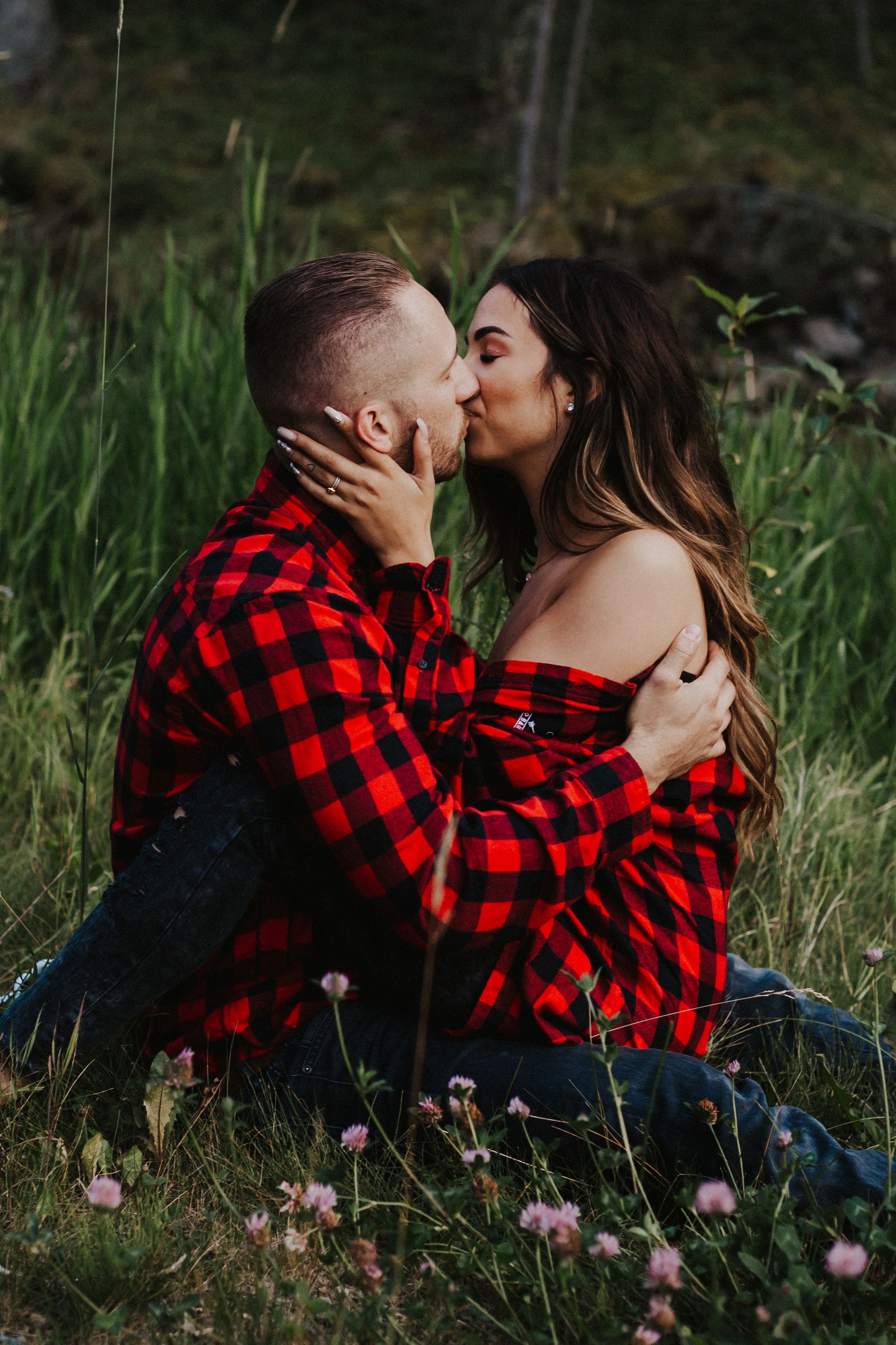 Couple in plaid kissing at anniversary photo session