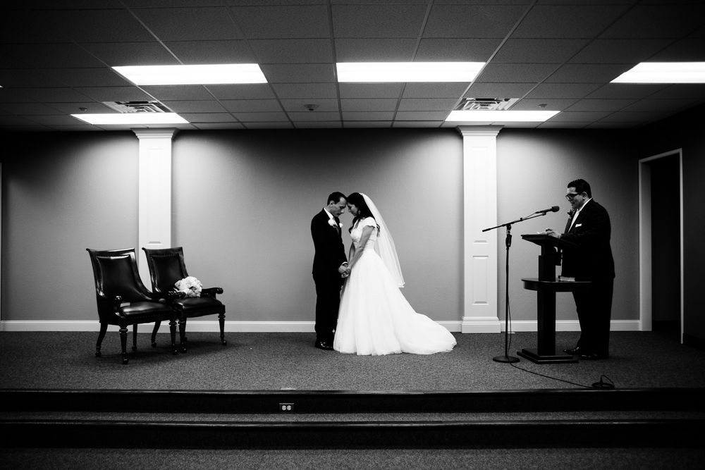 Bride and groom pray together after wedding ceremony