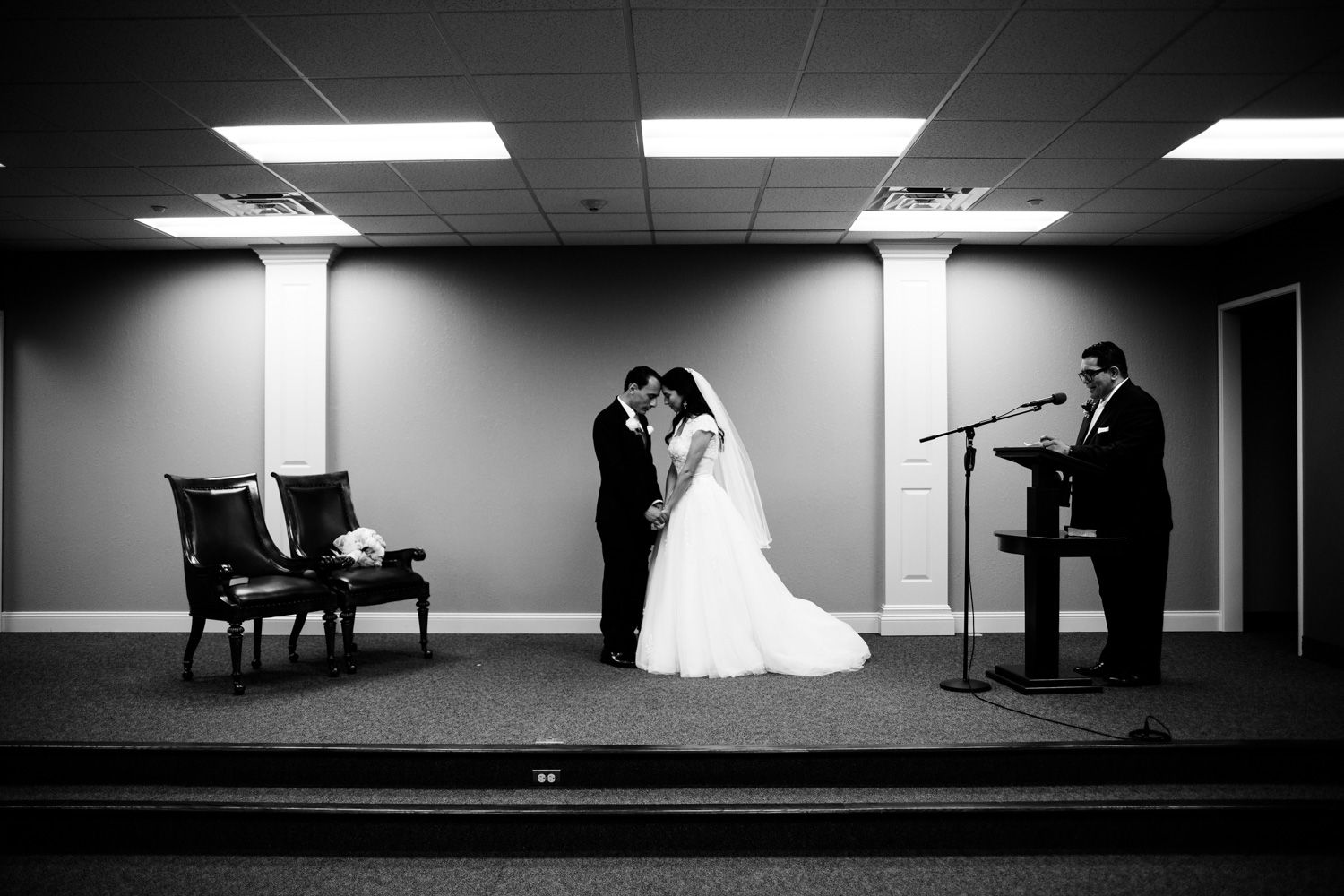 Bride and groom pray together after wedding ceremony