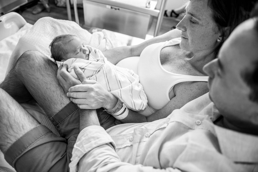 First moments with newborn baby captured in a Fresh 48 session by Heidi Harting Photography in Plymouth, MA