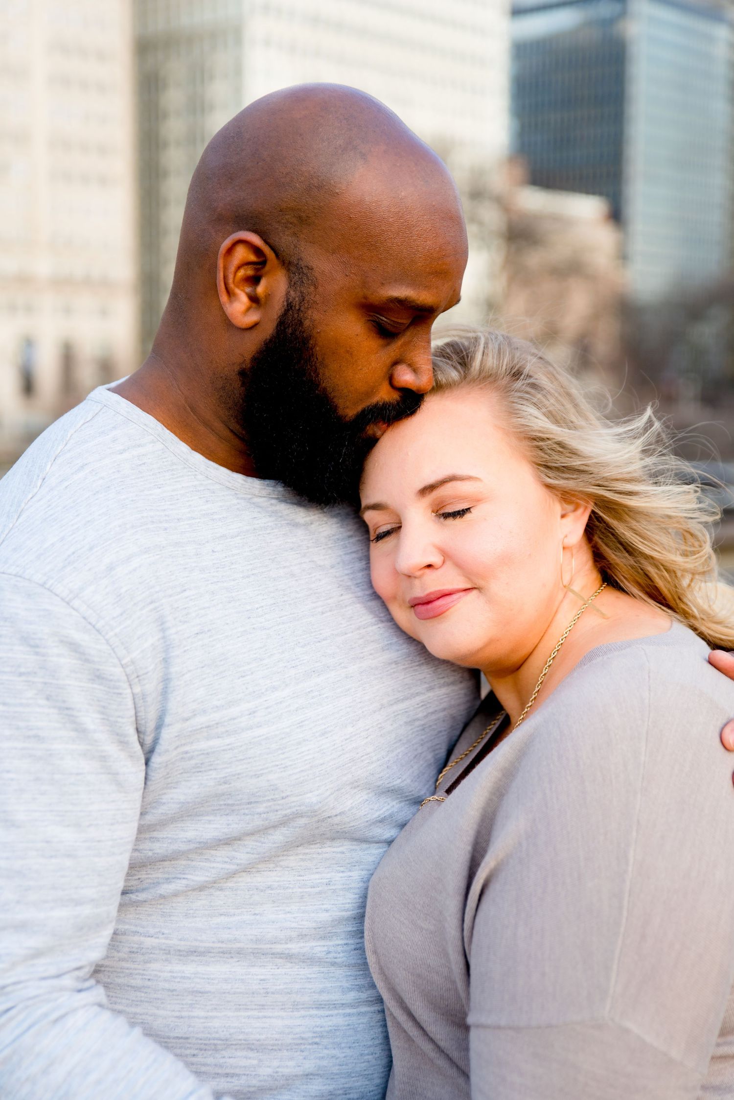 man kissing his fiance on forehead for Chicago sunrise engagement photos