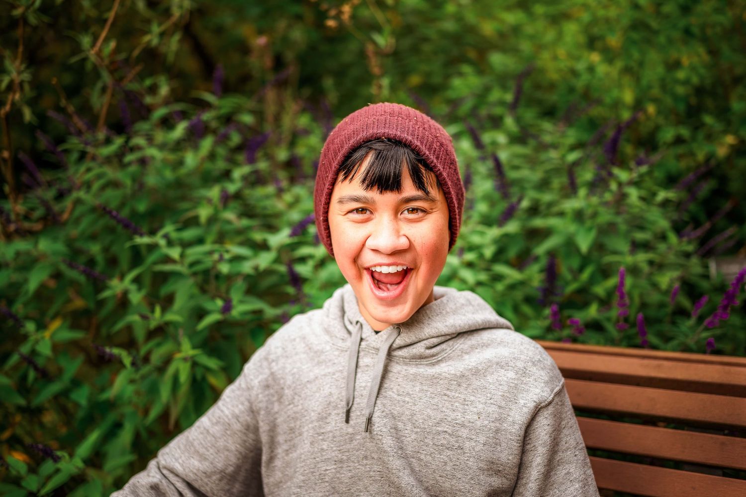 Portrait of boy with special needs smiling widely by Kate Cashin Photography