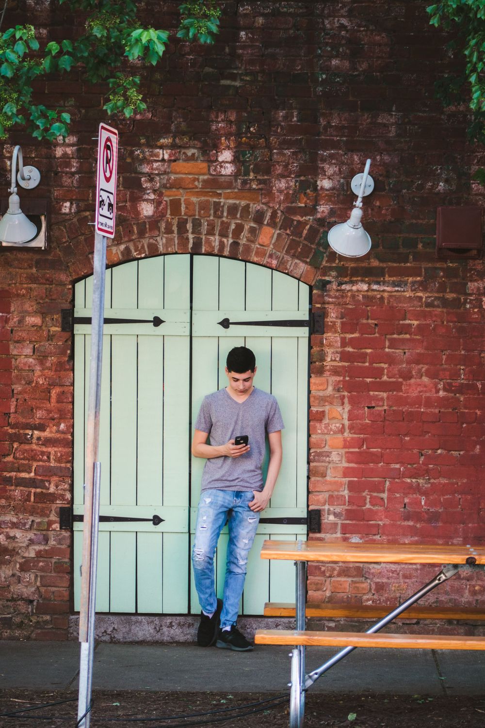 Young man texting on his phone in NODA