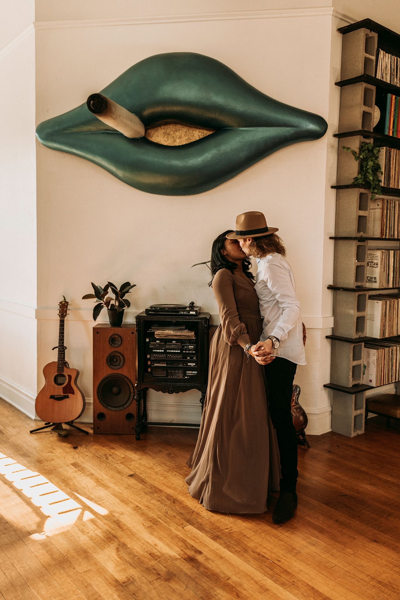 man and woman holding hands while dancing and kissing
