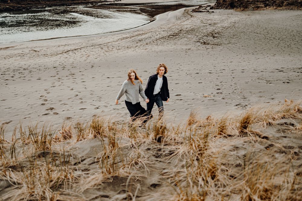 Couple in love in Piha for their engagement shoot with Apertured Media-Auckland Wedding Photographer