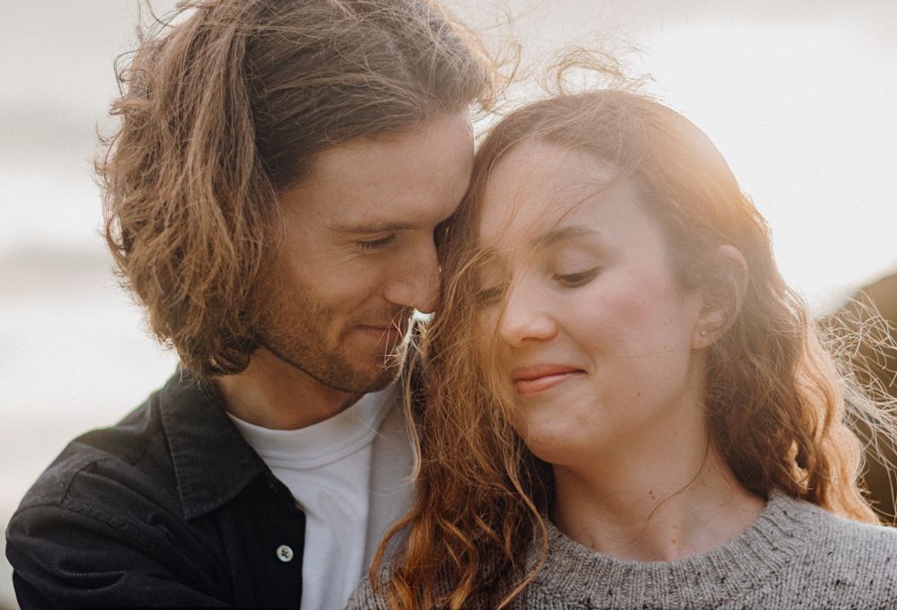 Couple deeply in love in Piha for their engagement shoot with Apertured Media-Auckland Wedding Photographer
