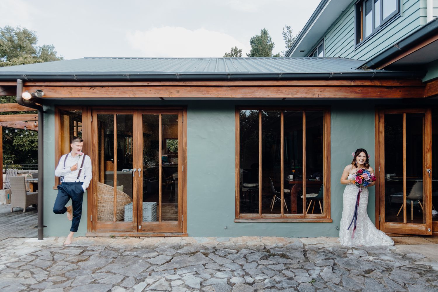 Modern storefront with wood and glass exterior featuring stone patio.