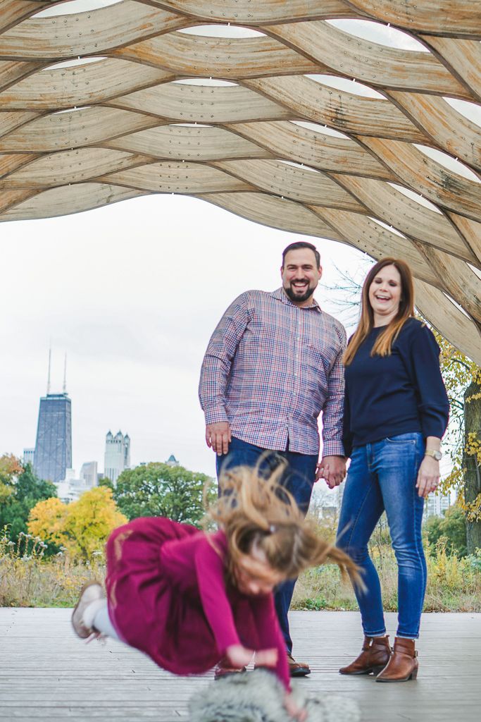 Humorous picture of little girl falling down during family photos
