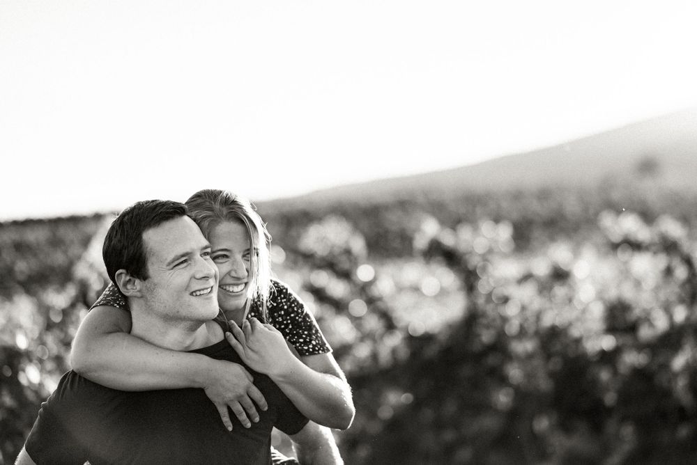 Couple in front of vineyards in Gumpoldskirchen, Austria doing a piggy back ride