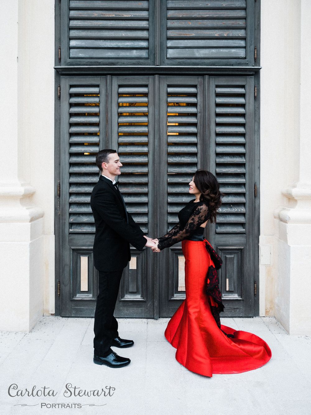 Couple holding hands in front of a door in Vienna, Austria