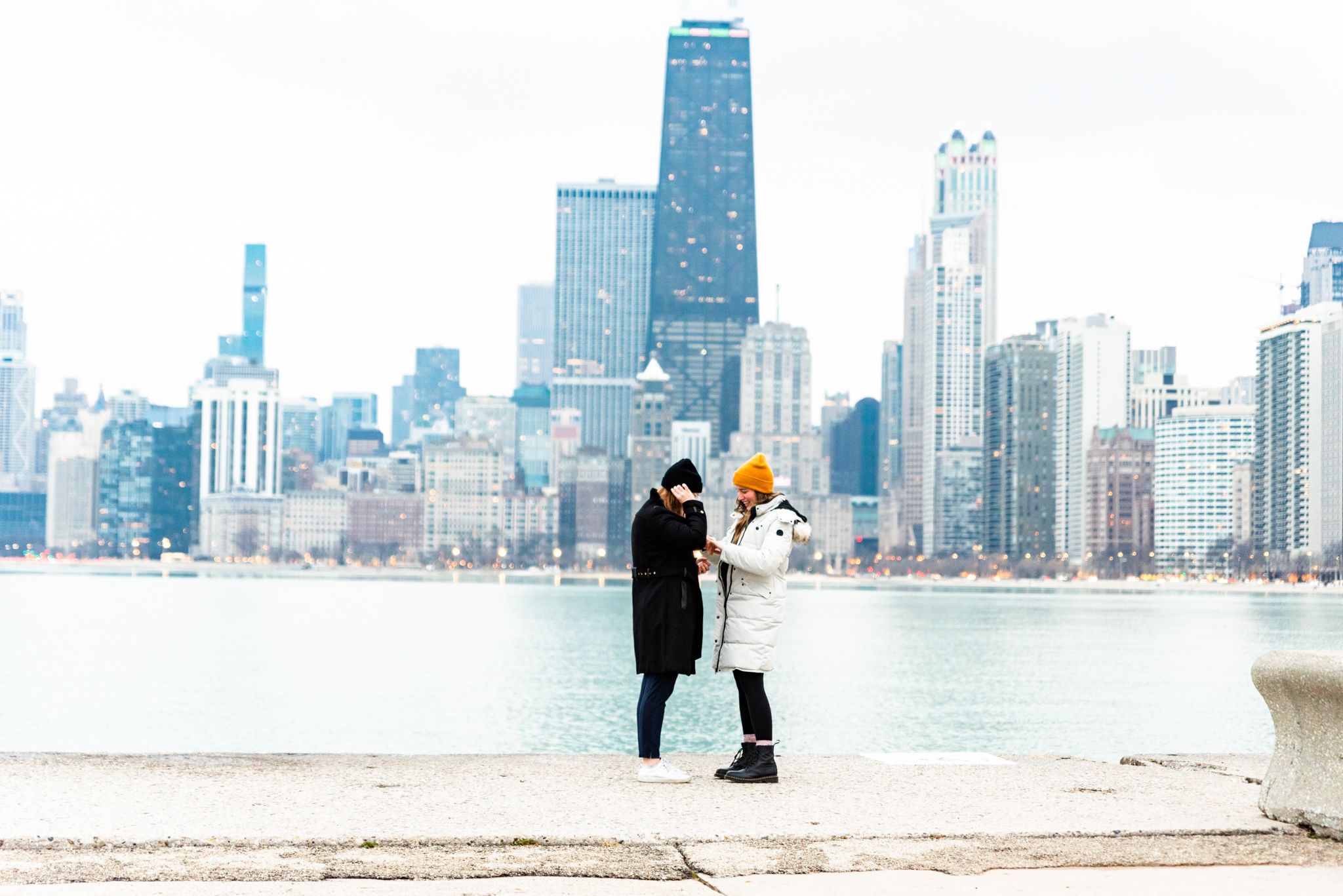 two women on pier at North Avenue Beach after Chicago proposal pictures