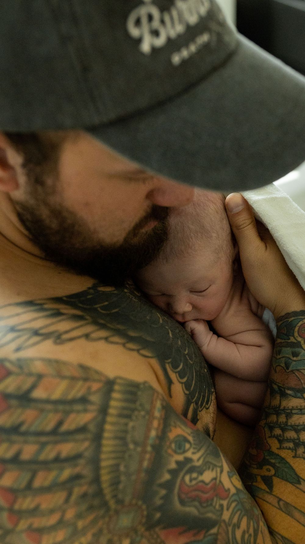 Dad cradles his newborn son moments after his hospital birth in Longmont Colorado.