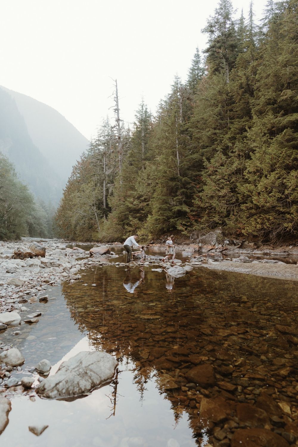 Family with small children crossing creek path at Olallie State Park