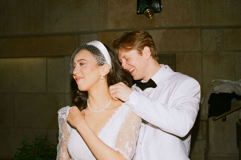 Montreal wedding photos captured on 35mm film groom putting necklace on bride