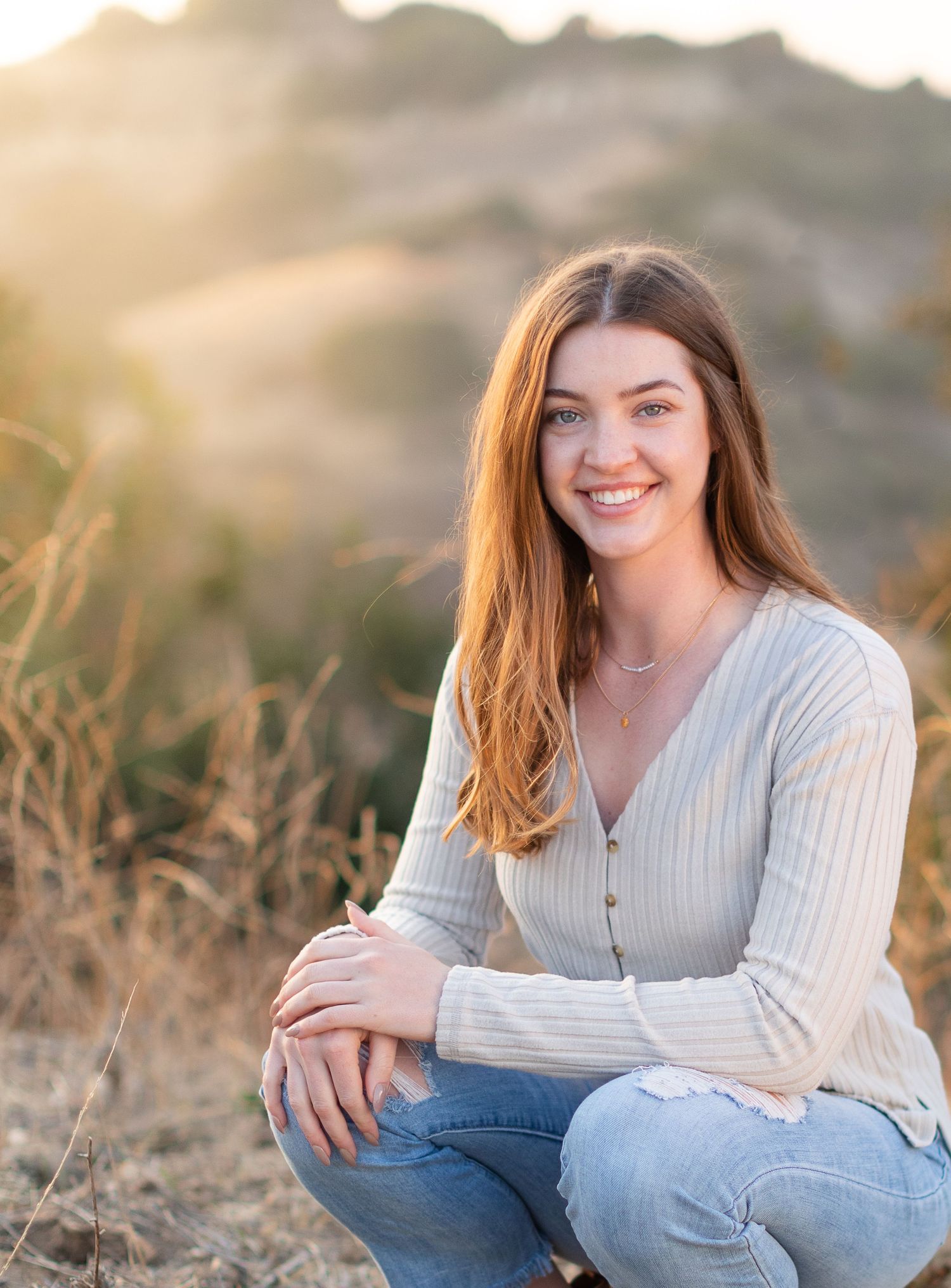 Young brunette lady in jeans on a mountain
