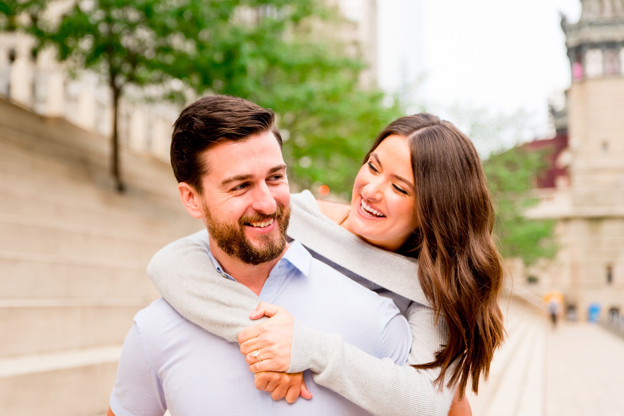 woman with brown hair laughing with fiance at Chicago Riverwalk sunrise engagement pictures
