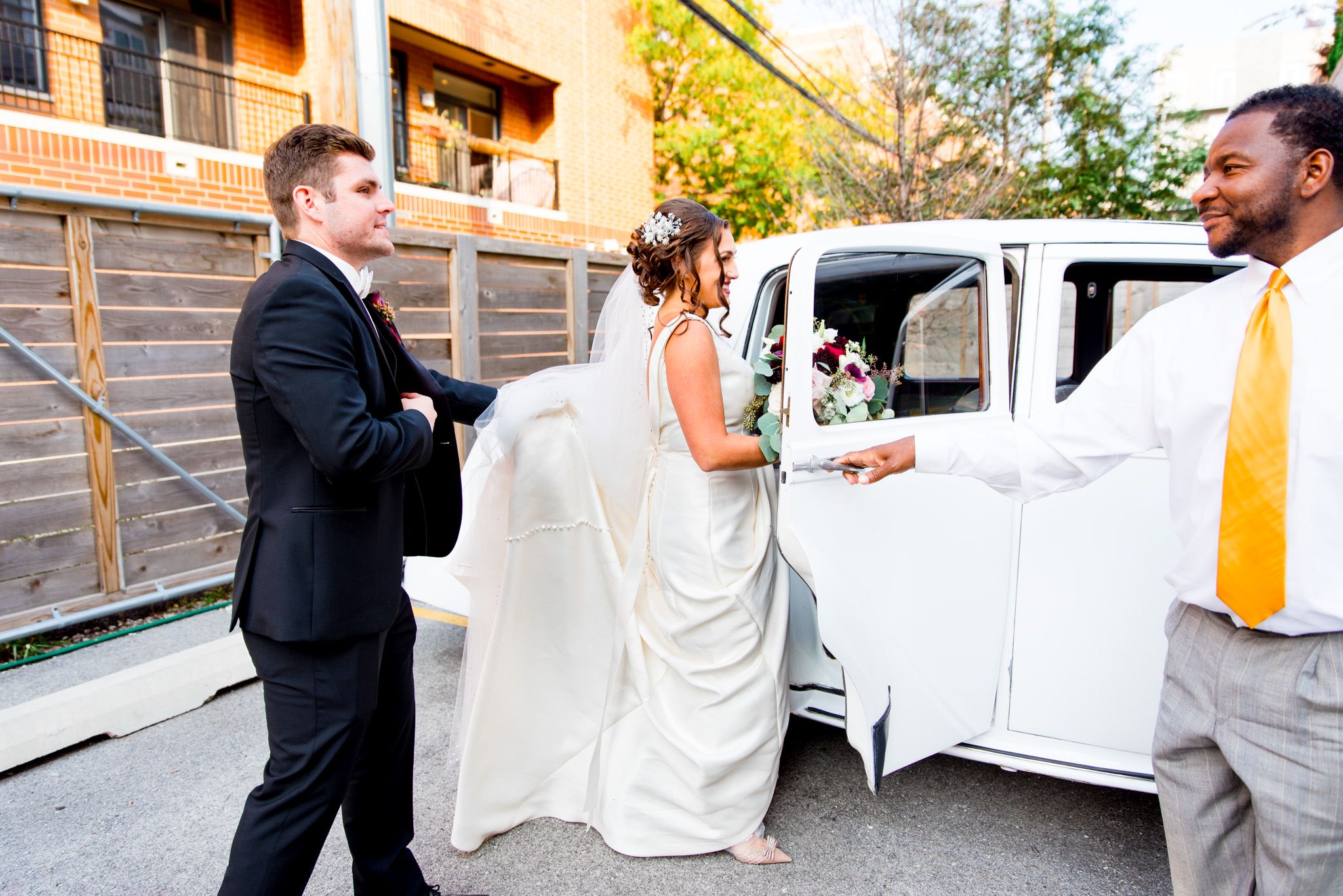 bride and groom enter white bentley after chicago wedding ceremony