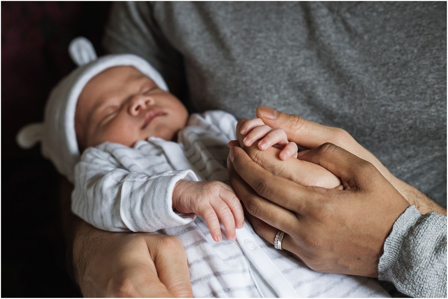 Close up images of a newborn baby boy holding his parents hands by Hannah Veale Family Photographer in Oxfordshire.