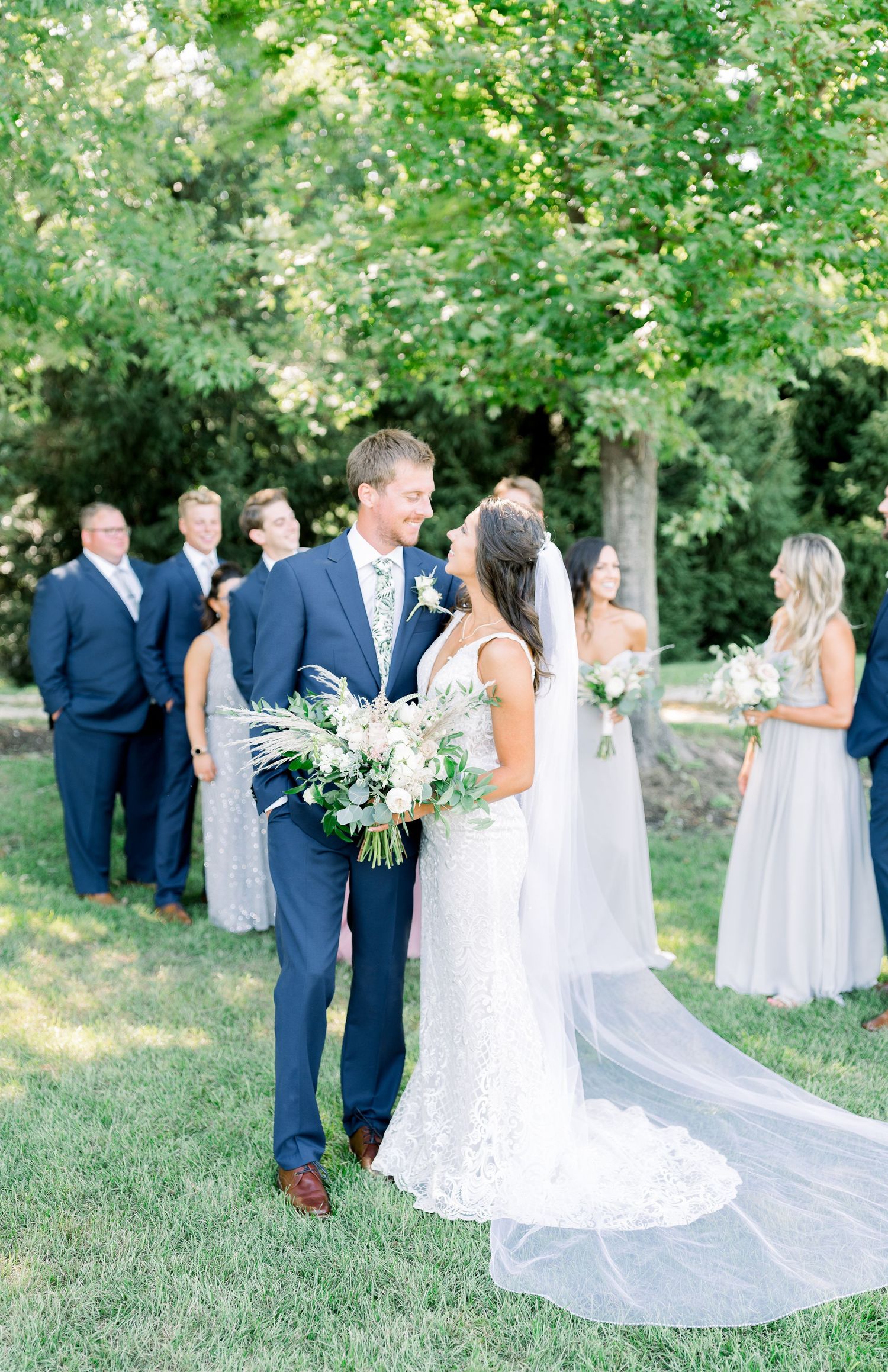 Vineyard bridal party photos with blue tuxes and pastel dresses at Prairie Moon Winery wedding in Ames, Iowa
