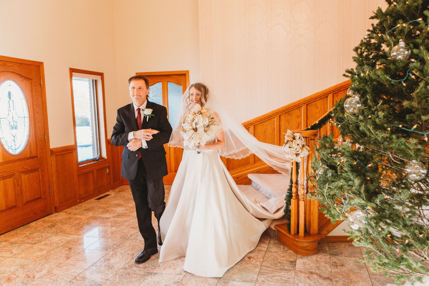 Bride walks down the aisle with her father during her Loveland, Colorado wedding.