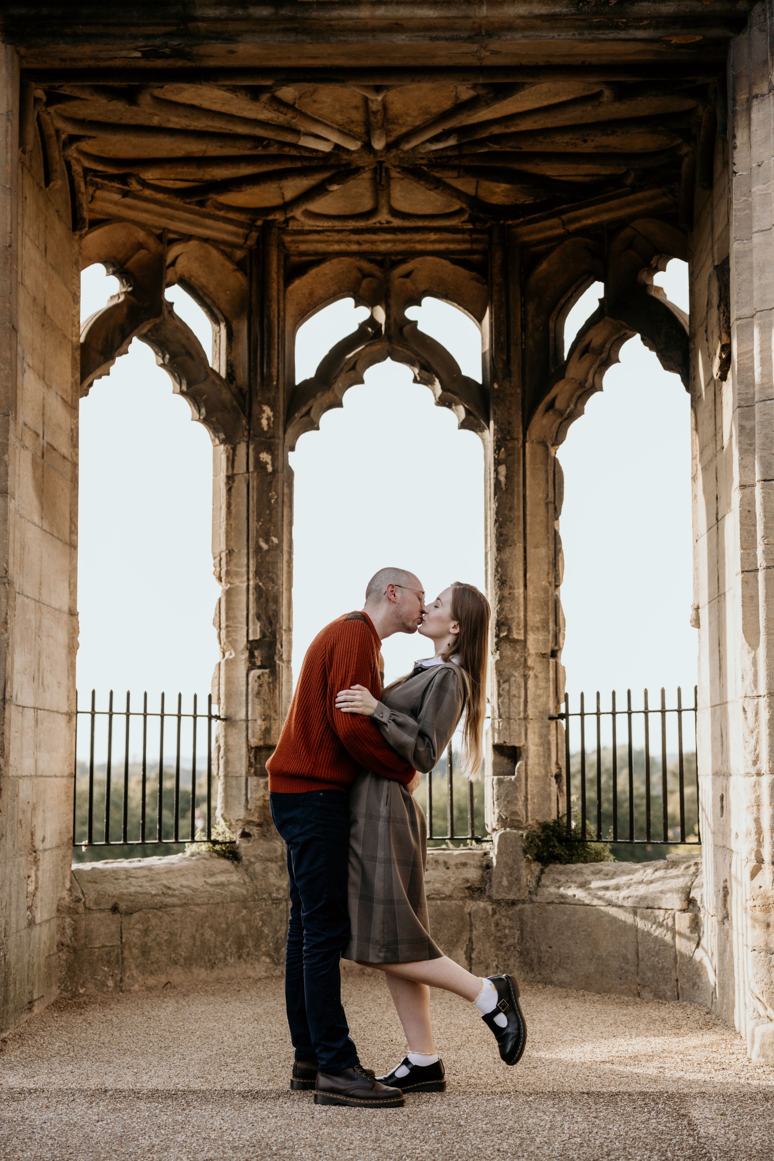 engaged couple kissing at Newark castle ruins